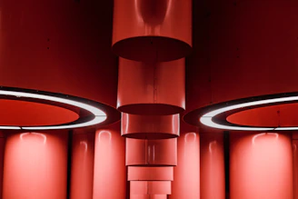 Shiny steel structural components arranged on a steel silver surface under soft lighting.