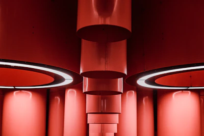 Shiny steel structural components arranged on a steel silver surface under soft lighting.