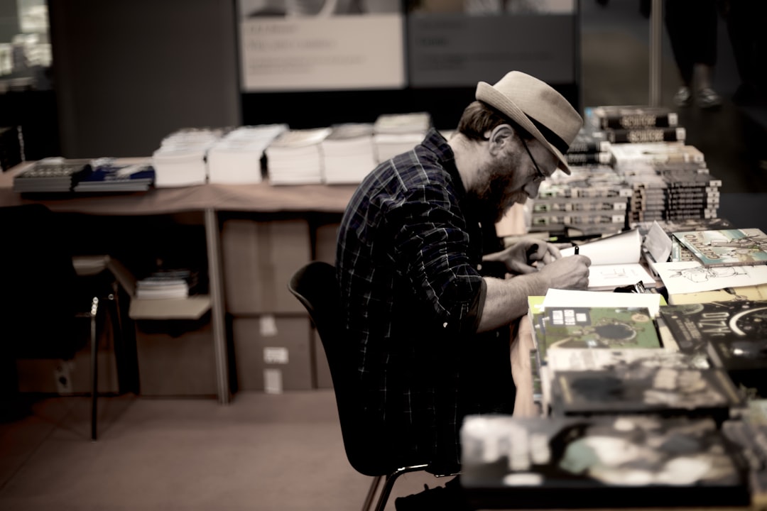 man in blue and black plaid dress shirt wearing brown cowboy hat