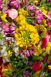 A vibrant floral arrangement showcasing various types of flowers and greenery.