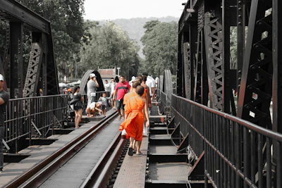 people walking on train rail during daytime
