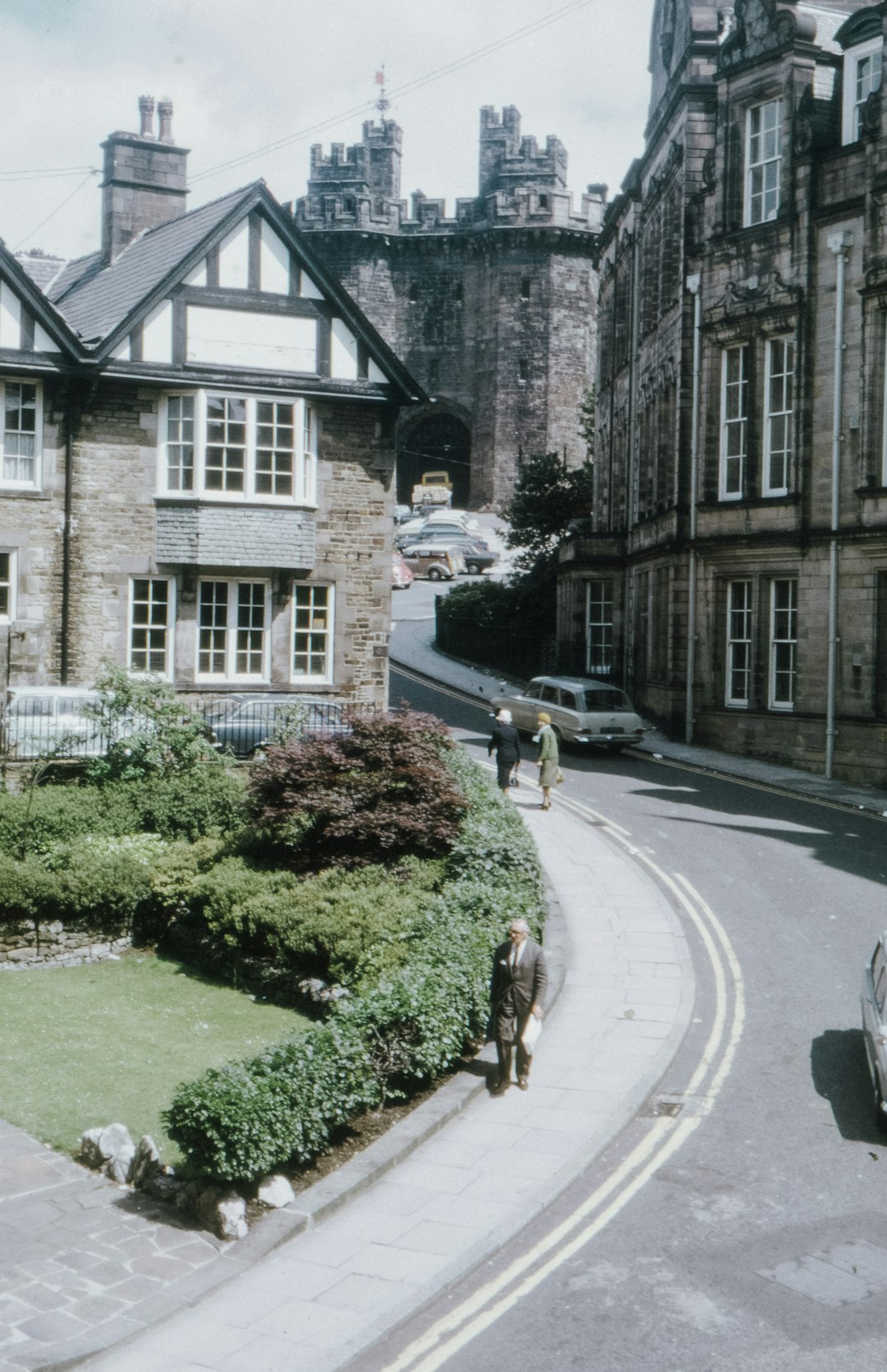 black car parked beside green grass lawn during daytime