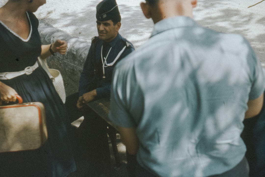 man in blue shirt standing beside man in black jacket