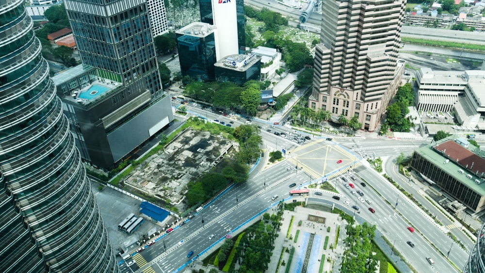 cars on road near high rise buildings during daytime