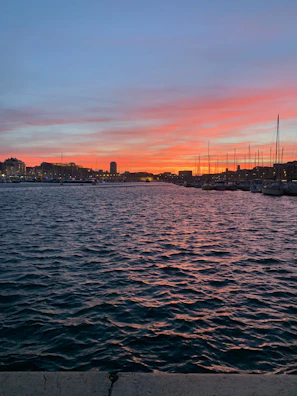 A picturesque harbor at dusk where the ship moors after a day of swimming and exploration.