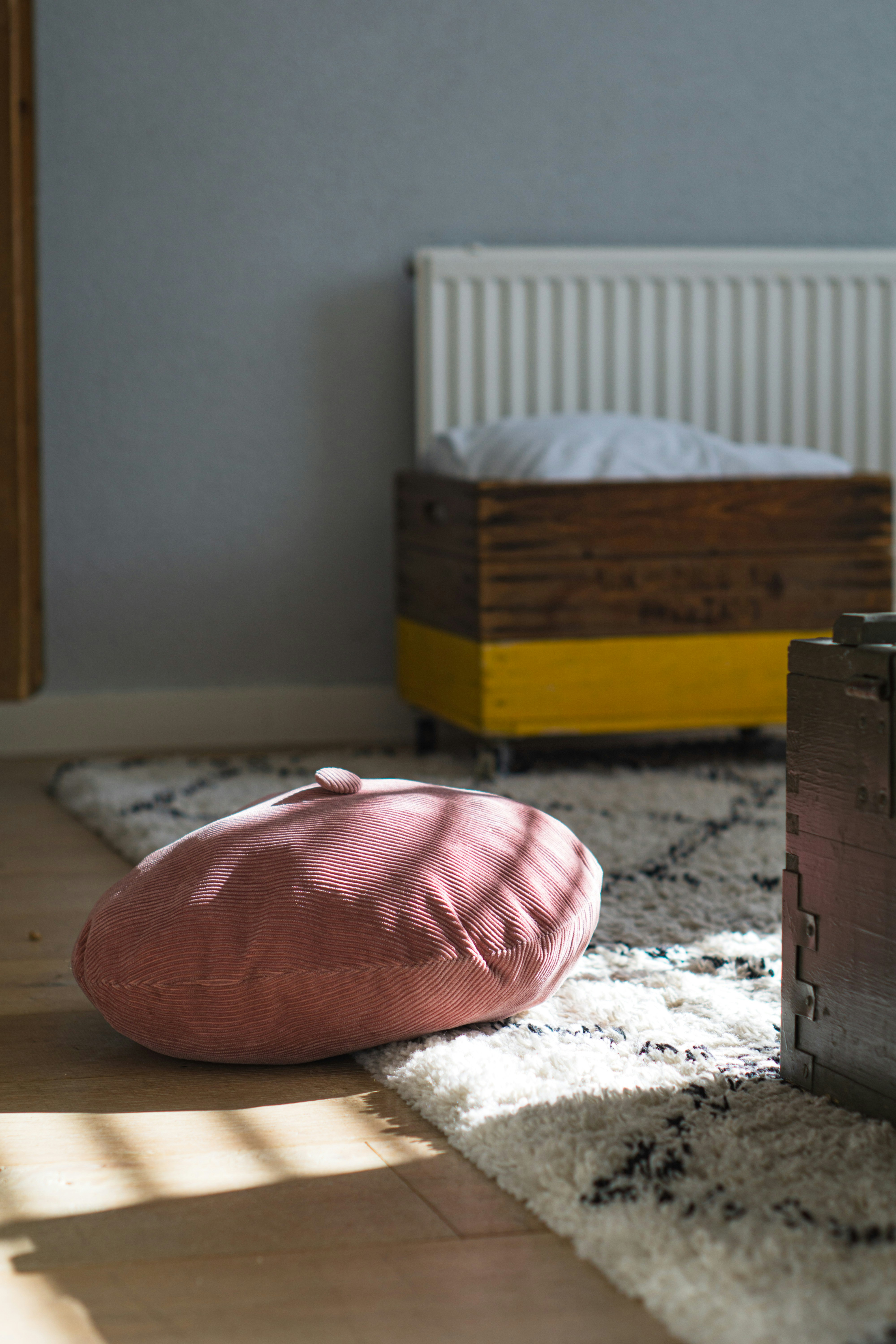 Easy Ways to Make Your Home Feel Cozy Without Spending a Fortune – pink and white pillow on white and red floral bed linen