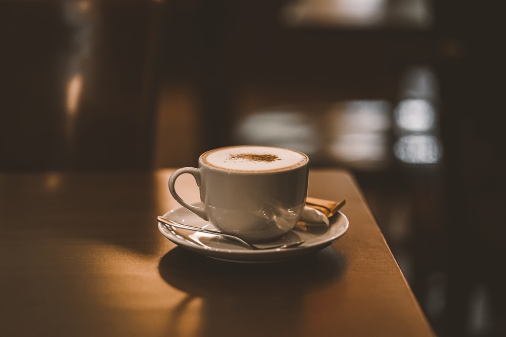 white ceramic cup on saucer