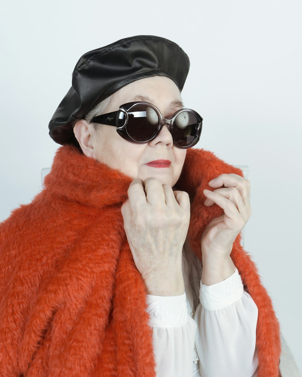 woman in black knit cap and white framed sunglasses