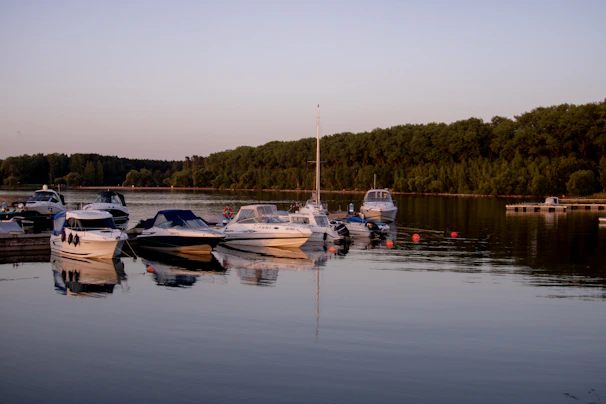 Evening lights reflecting on the calm waters of Zugersee with boats docked