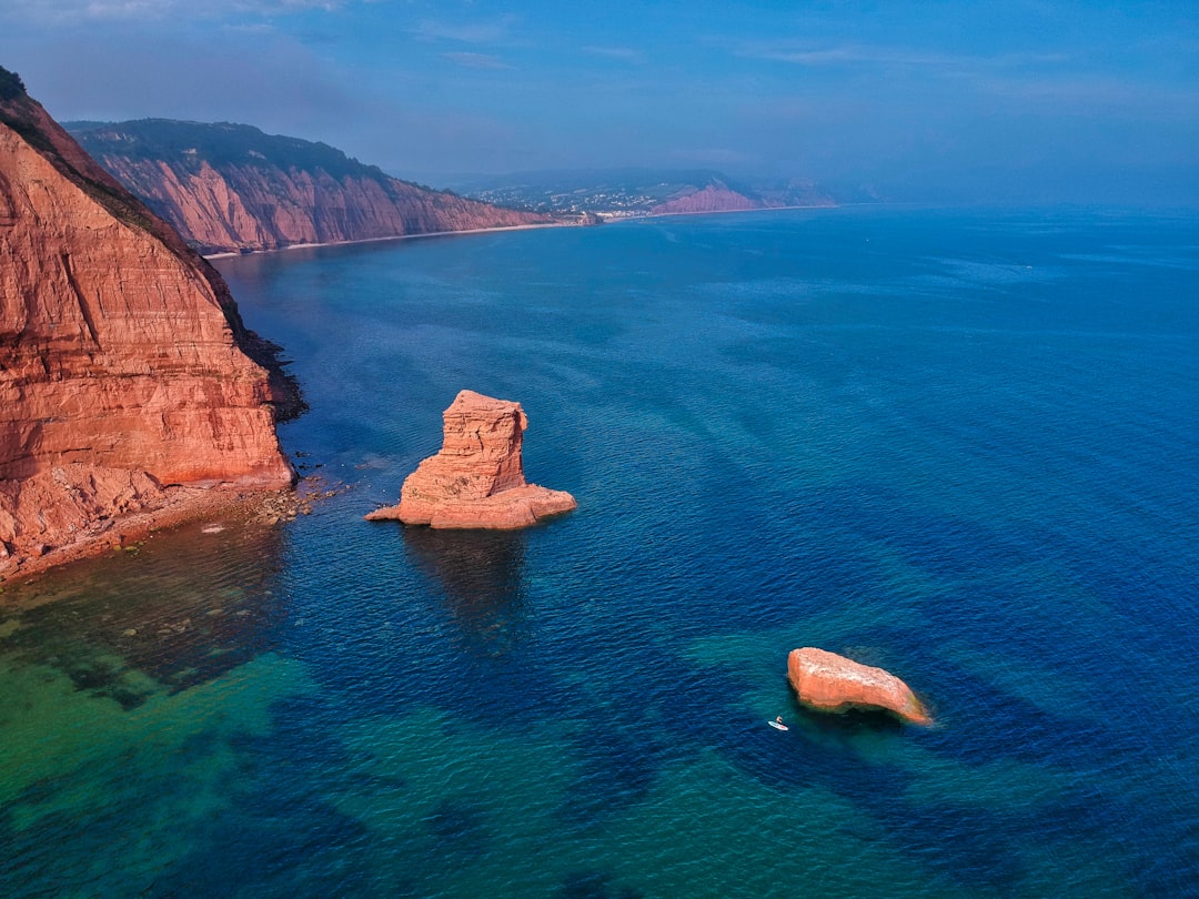 brown rock formation on blue sea during daytime