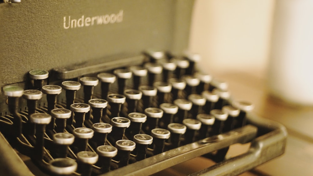 black and white typewriter on brown wooden table