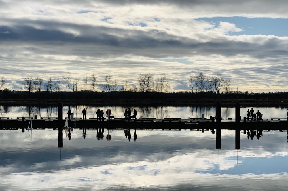 people walking on water during sunset