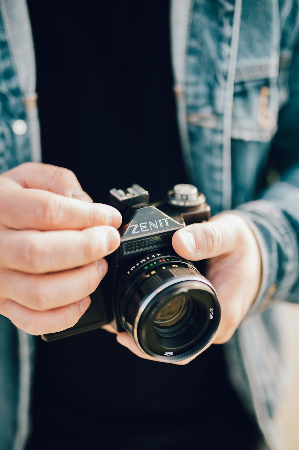 person holding black nikon dslr camera