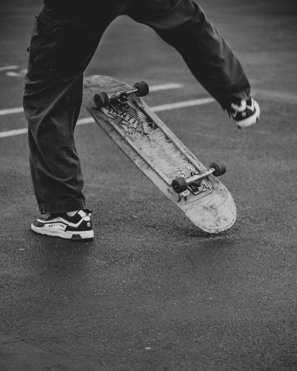 grayscale photo of man riding skateboard