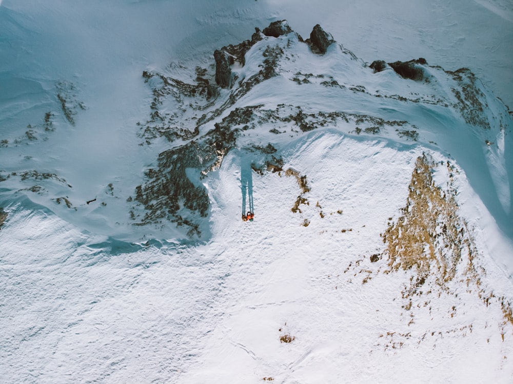 person in green jacket walking on snow covered ground during daytime