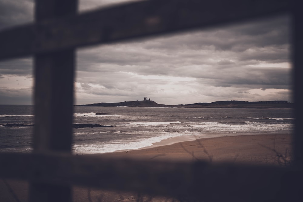 silhouette of person walking on seashore during daytime