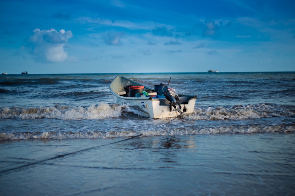 white and black motor boat on sea under blue sky during daytime