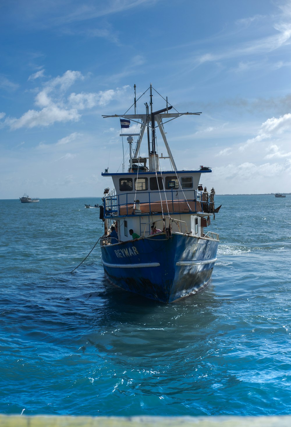 brown and black boat on sea under blue sky during daytime