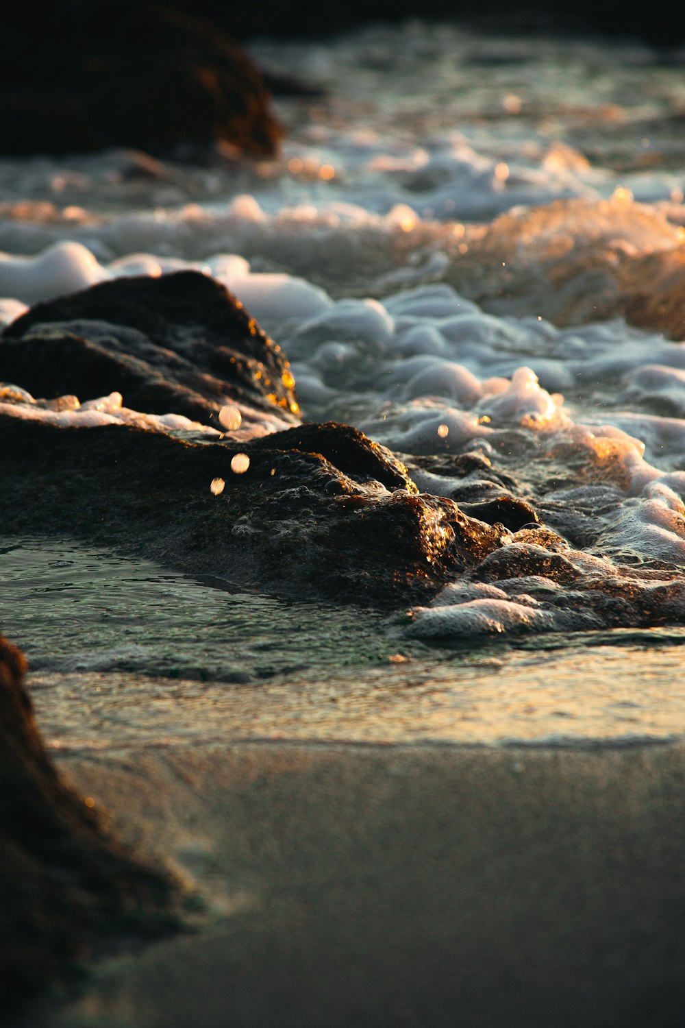 brown rock on body of water during daytime