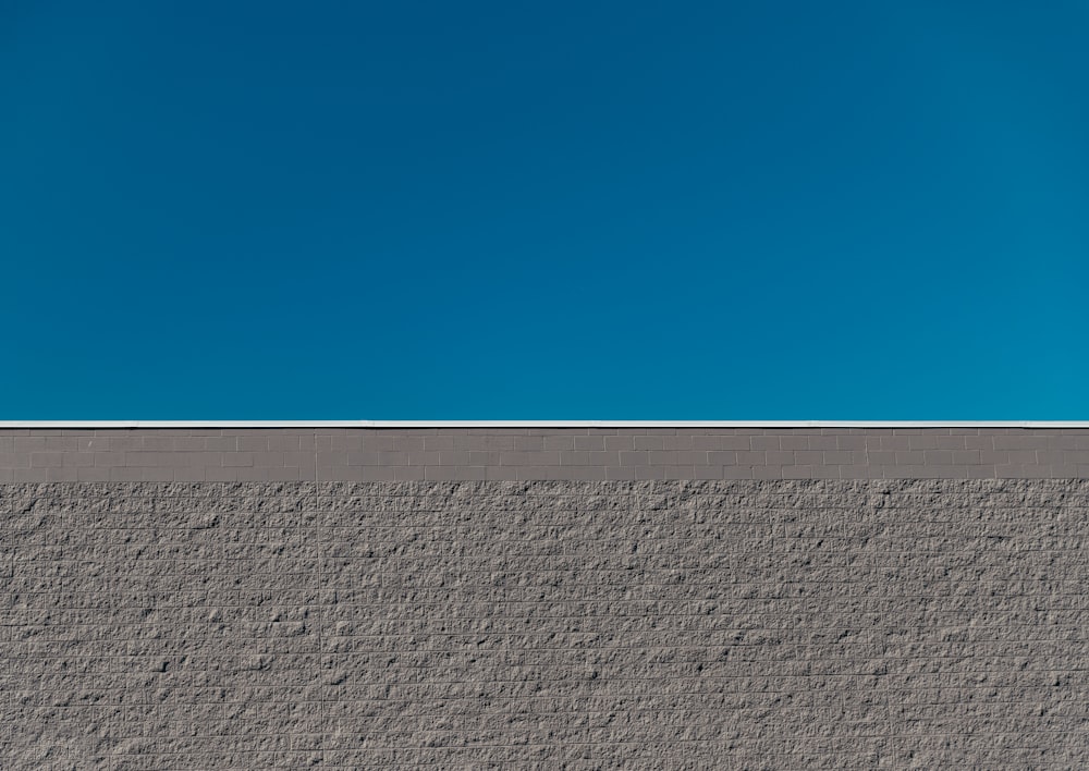 gray concrete wall under blue sky during daytime