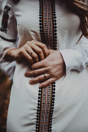 A close-up of traditional wedding rings on a decorative cloth.