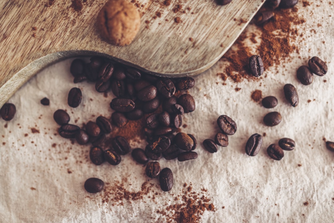 brown coffee beans on brown wooden chopping board