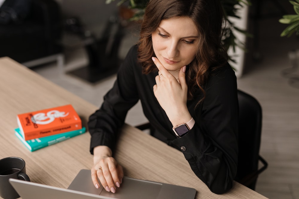 woman in black blazer sitting at the table