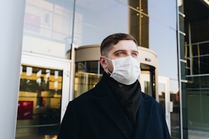 man in black robe wearing white face mask