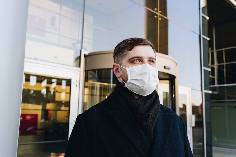 man in black robe wearing white face mask