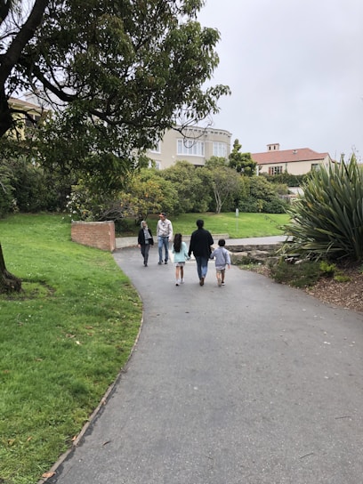 A group of diverse people walking in a park.