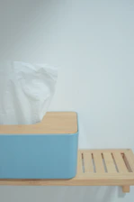 Close-up of a sleek, modern tissue box with vibrant branding on a clean white background.