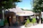 A cozy wooden shed with a welcoming sign that says 'Google Reviews Here' beside a tablet showing the review page.