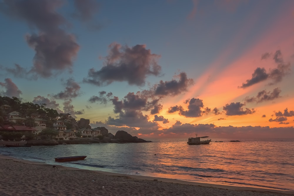 silhouette of boat on sea during sunset