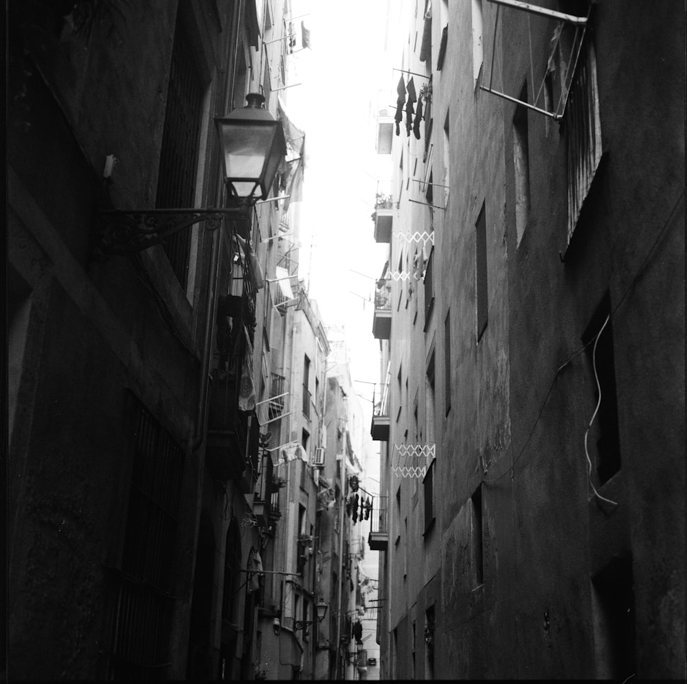 grayscale photo of alley between buildings