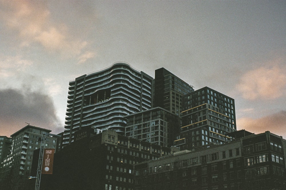 black and white concrete building under cloudy sky