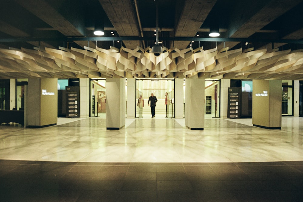 people walking on white floor tiles