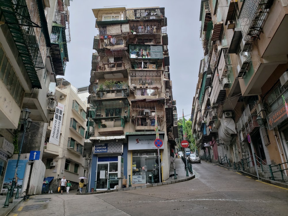 cars parked on sidewalk near buildings during daytime