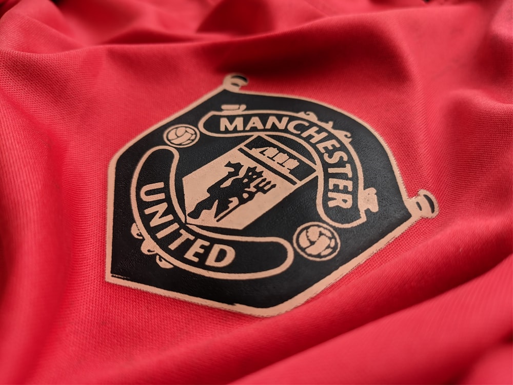 a manchester united emblem on a red shirt