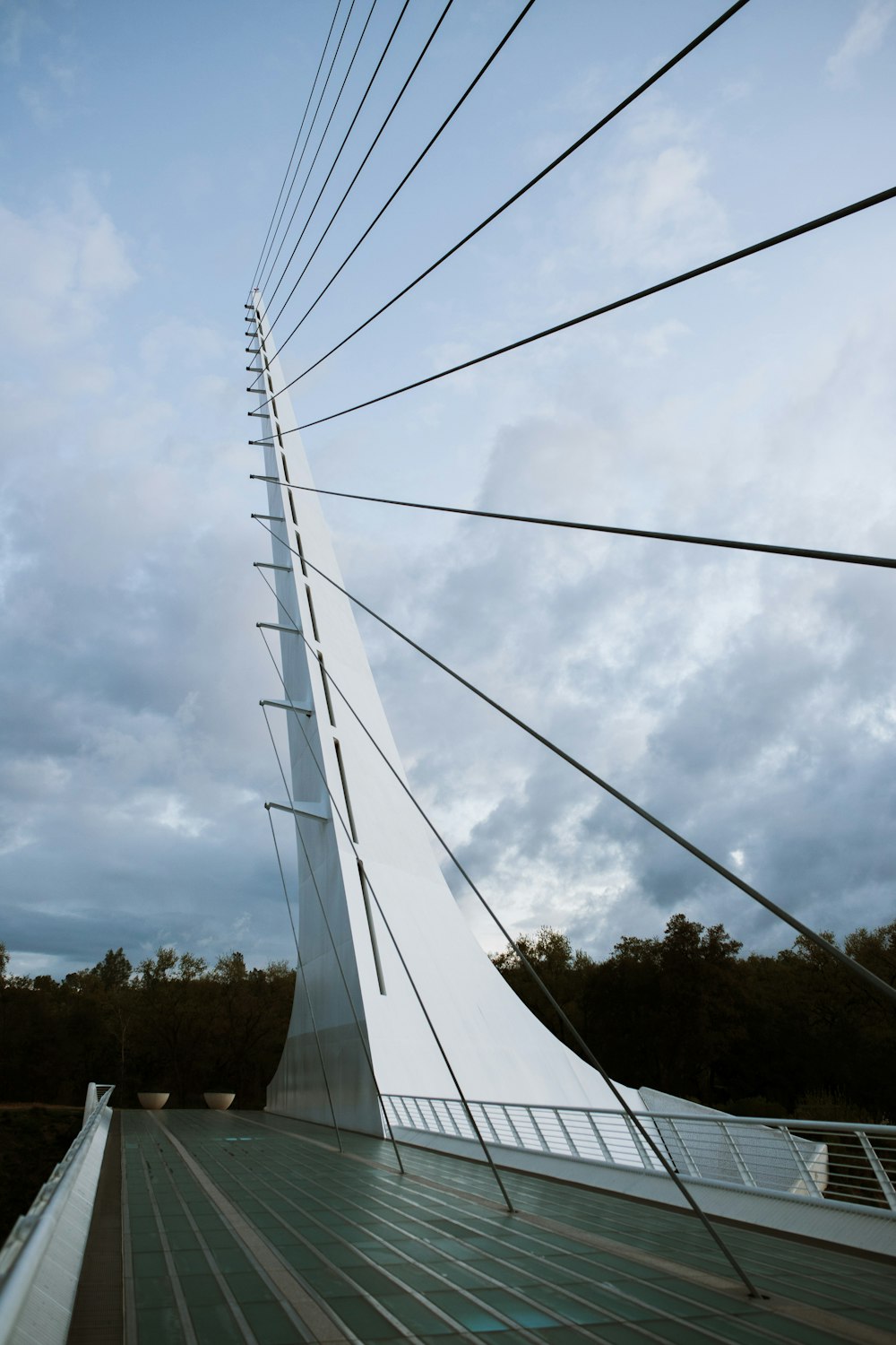 white metal bridge under white clouds during daytime