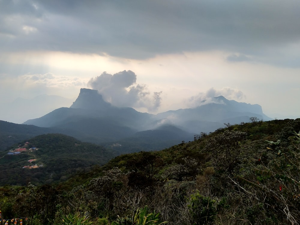 green mountain under white clouds during daytime