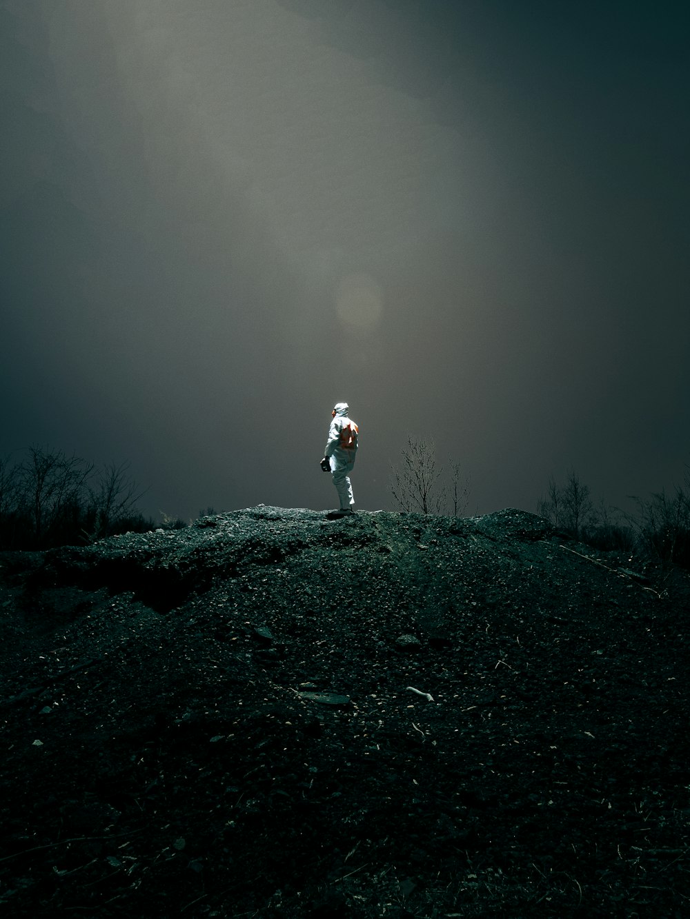 person in white jacket and pants standing on ground covered with snow during daytime