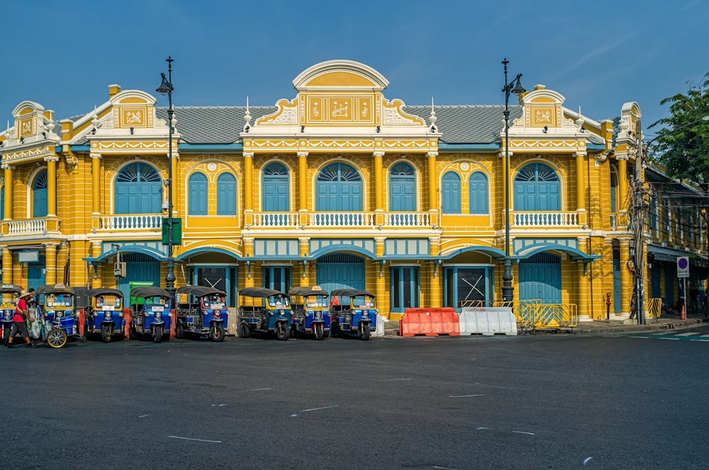 cars parked in front of yellow building