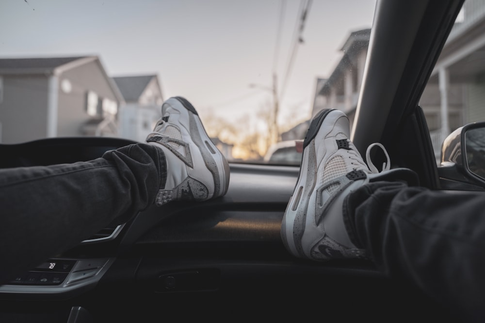 person wearing black and white nike sneakers