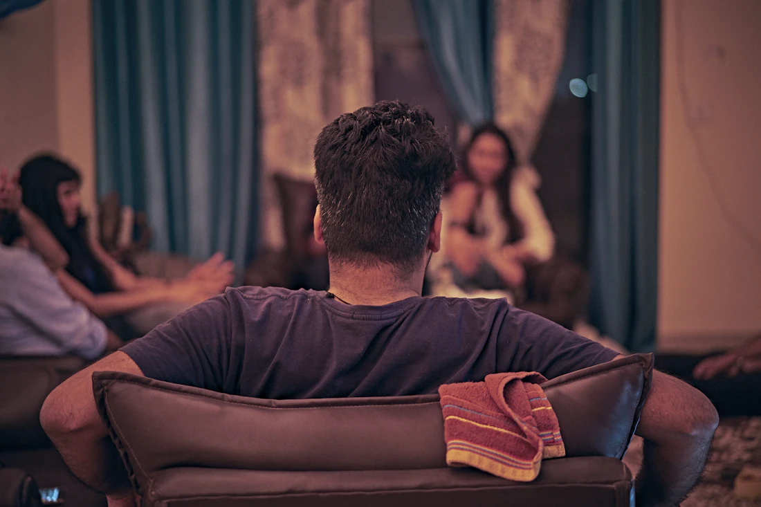 A man at home in an armchair in the evening