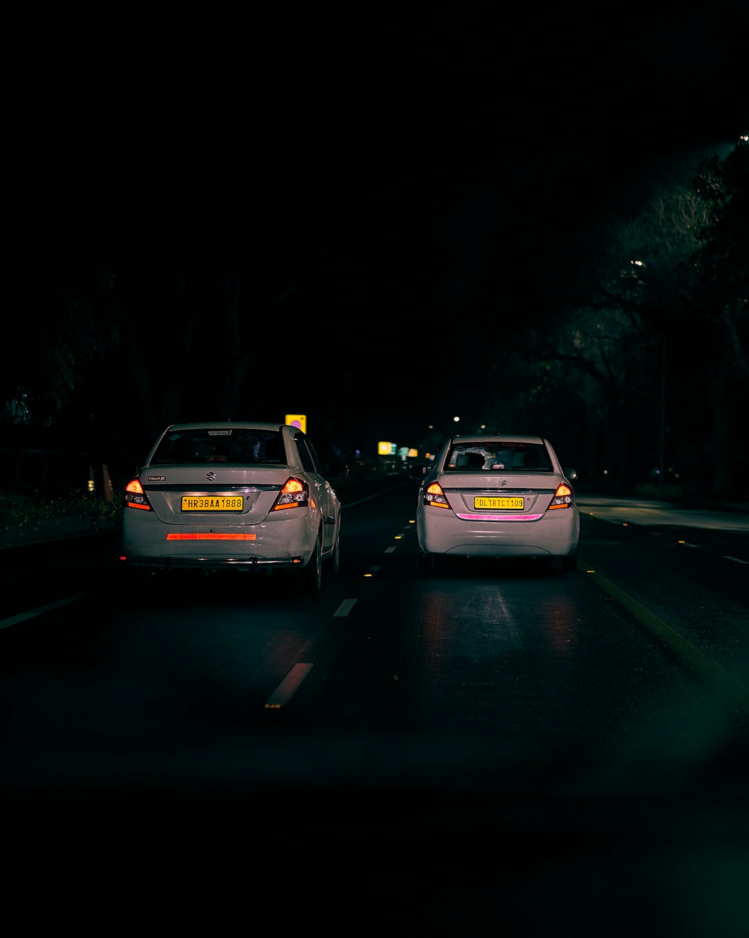 white car on road during night time