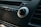 Close-up of a car stereo system focusing on a knob labeled 'Tune/Sound' surrounded by buttons and a dark, textured dashboard.