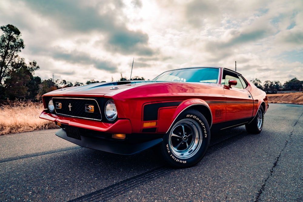 red chevrolet camaro on road during daytime