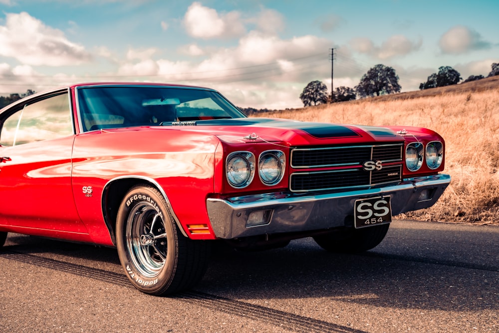 red chevrolet camaro on road during daytime