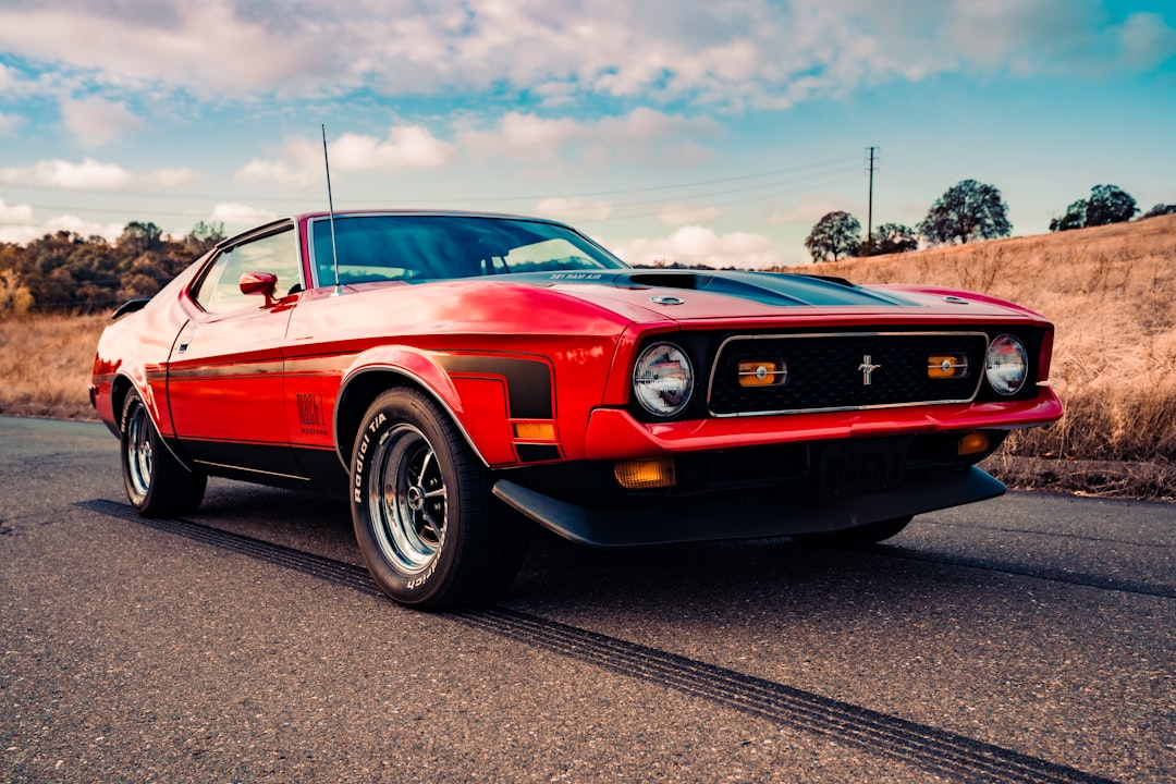 red chevrolet camaro on road during daytime