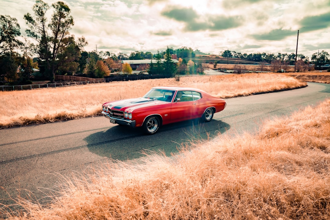 red sedan on road during daytime